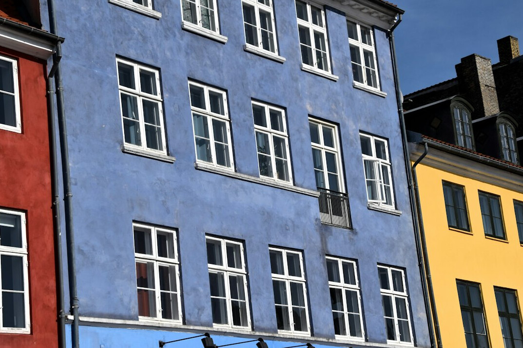 Quiet cobblestone street in a Danish town with pastel colored houses